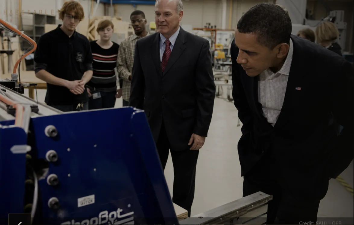 Fellows working around a machine demonstration