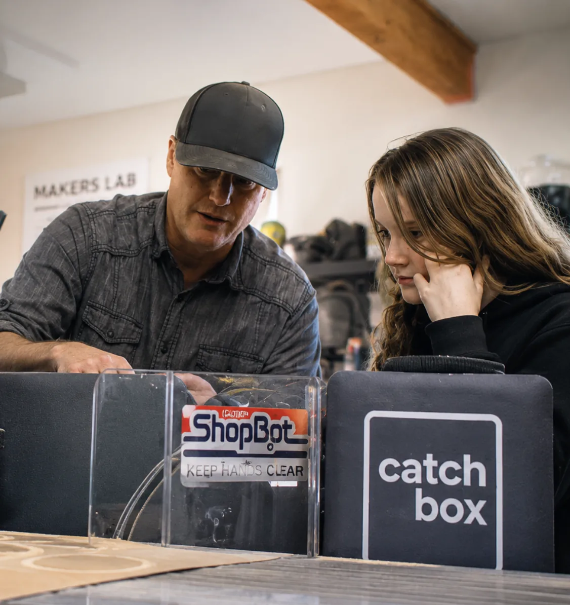 A mentor and student learning near a ShopBot CNC machine